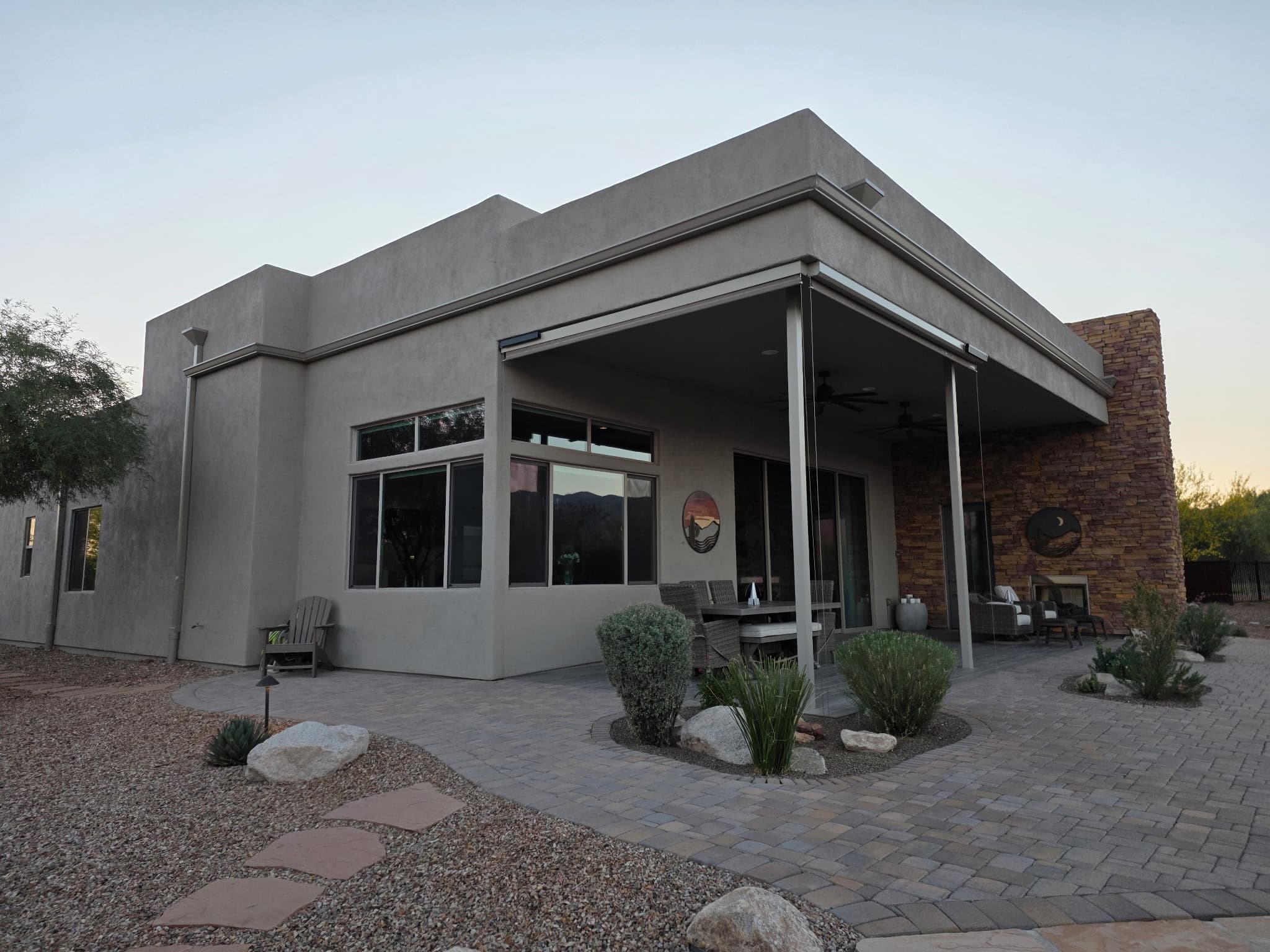 Contemporary Tucson custom home with seamless gutter at golden hour