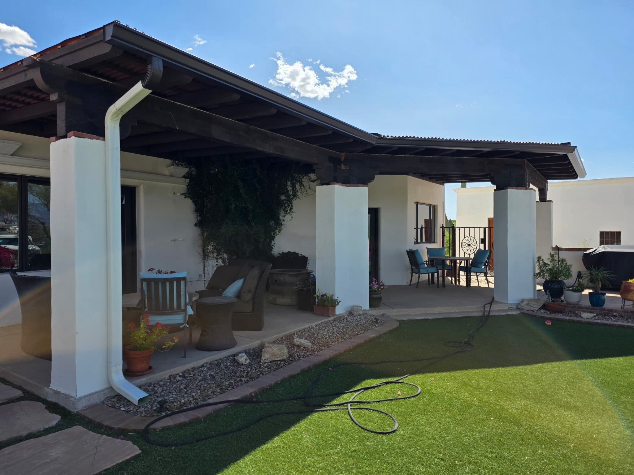 Seamless white gutter and downspout on a Tucson hacienda patio