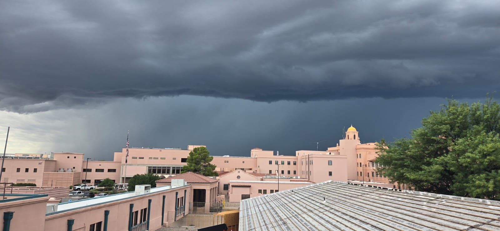 Storm clouds over a Tucson tile roof after a monsoon